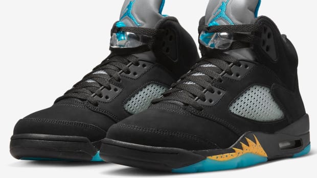 View of black and aqua Air Jordan shoes.